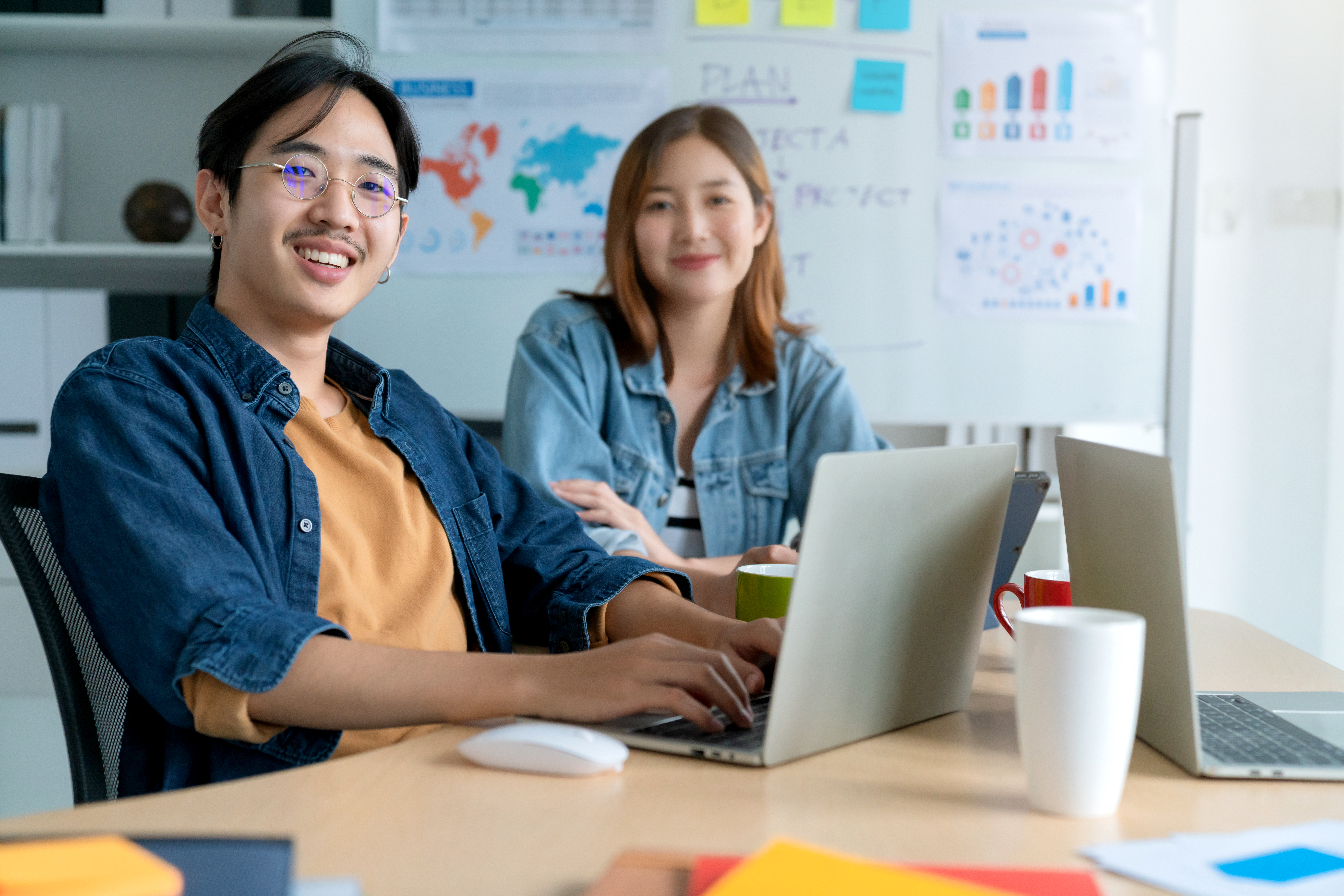 Asian colleague male and female friend casual dress meeting consult work together with fun and happiness  in workplace business partners relation ideas concept