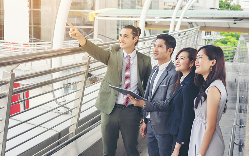 Property managers surveying a modern outdoor commercial development.